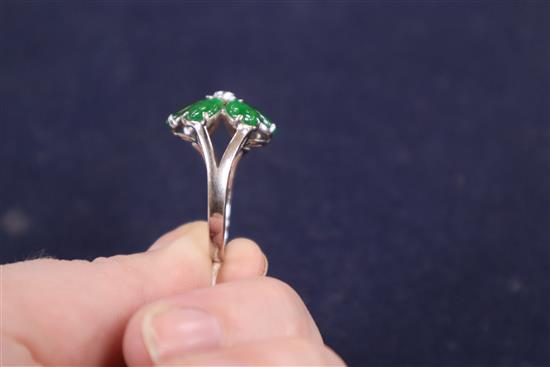 A modern 18k white metal, jadeite and diamond set flowerhead cluster ring, size P.
